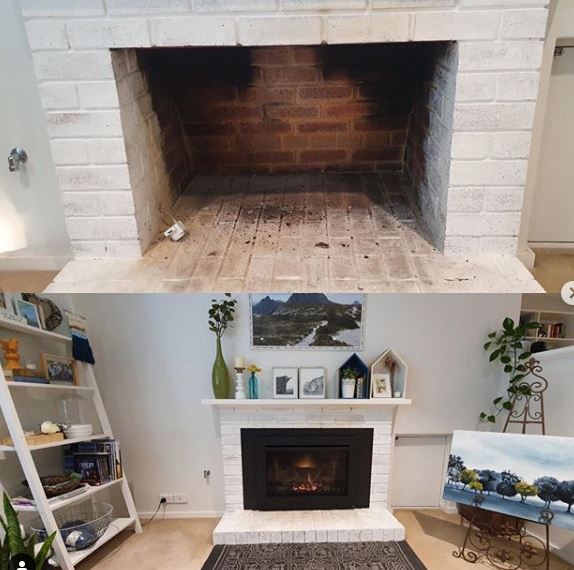 A gas fireplace insert installed in a masonry fireplace
