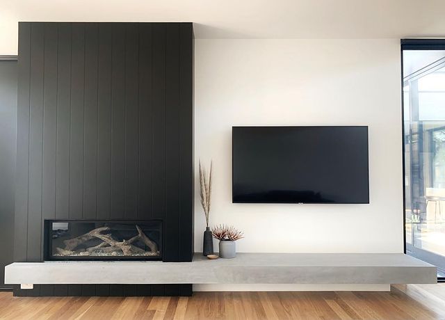 Wood fireplaces in driftwood wall beside television - Lopi Fireplaces Australia